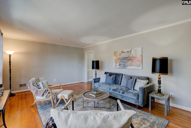 living room featuring light hardwood / wood-style flooring and ornamental molding