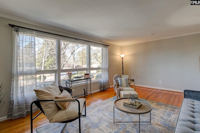 living room with ornamental molding and light wood-type flooring