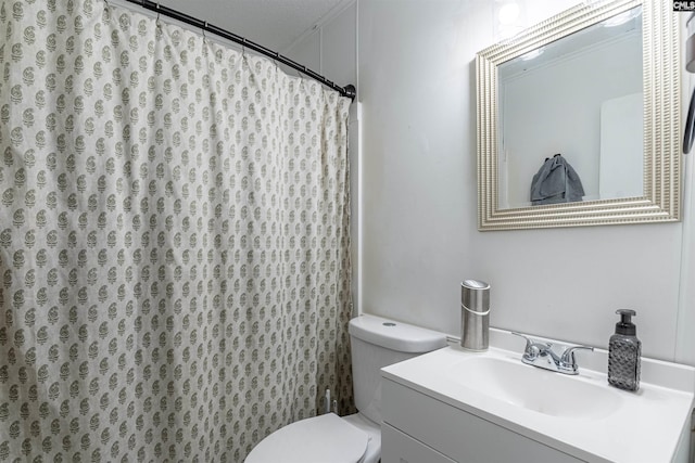 bathroom with vanity, a textured ceiling, and toilet