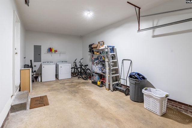 garage featuring electric panel and washing machine and dryer