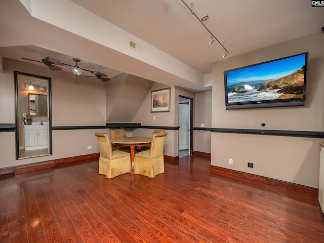 unfurnished dining area with hardwood / wood-style flooring, rail lighting, and ceiling fan