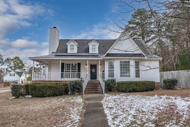 view of front of house featuring covered porch and solar panels