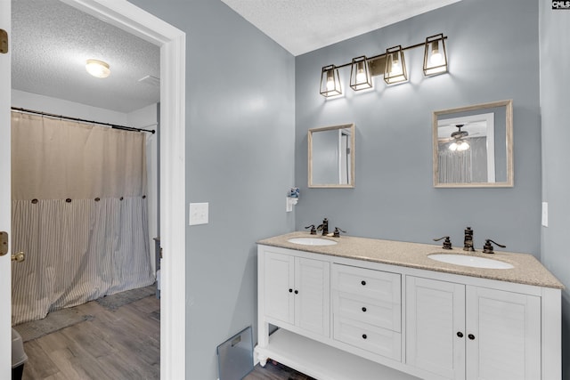 bathroom with vanity, hardwood / wood-style flooring, a textured ceiling, and a shower with shower curtain