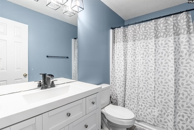 bathroom with vanity, a textured ceiling, and toilet