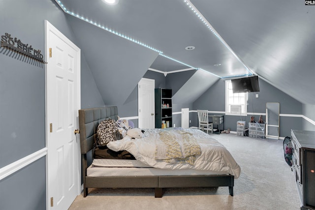 bedroom featuring light colored carpet and lofted ceiling