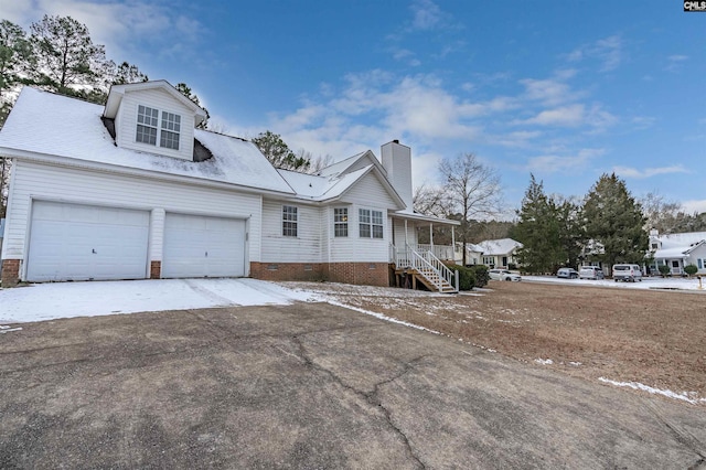 view of front of house with a garage and covered porch