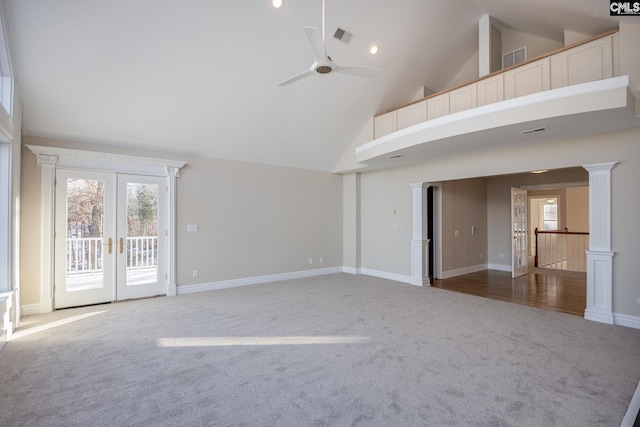 unfurnished room with carpet floors, high vaulted ceiling, ceiling fan, and ornate columns