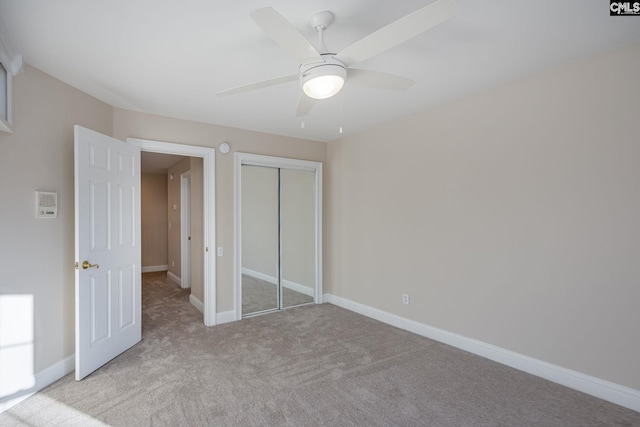 unfurnished bedroom with light carpet, ceiling fan, and a closet