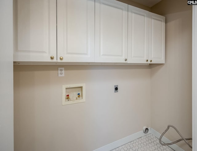 clothes washing area with washer hookup, electric dryer hookup, light tile patterned floors, and cabinets