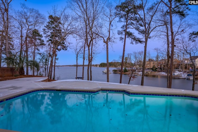 view of swimming pool featuring a water view