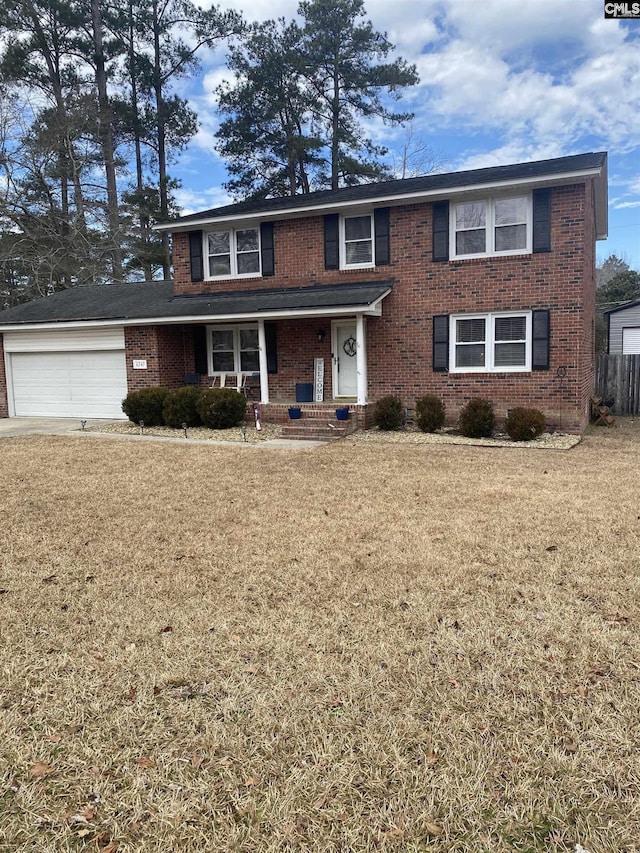 view of front of property with a garage, a porch, and a front lawn