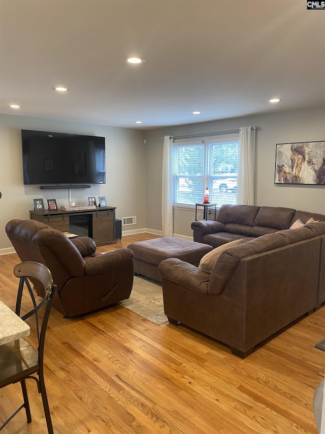 living room with light hardwood / wood-style floors