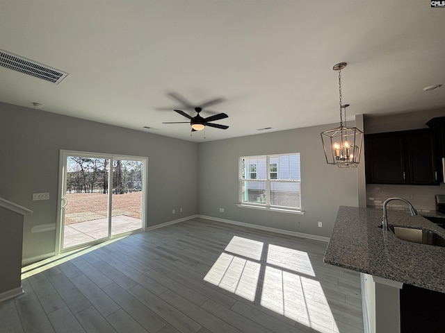 interior space with a healthy amount of sunlight, visible vents, a sink, and wood finished floors