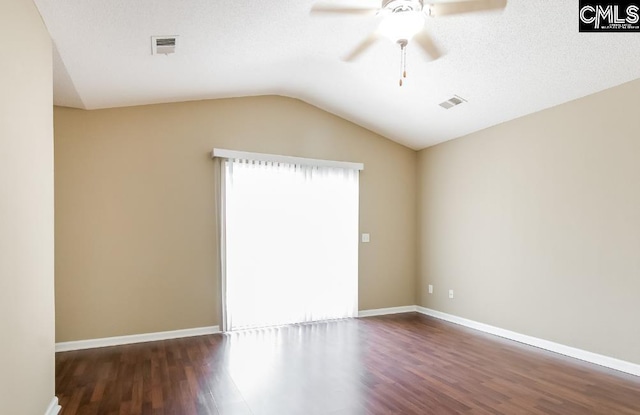 empty room featuring lofted ceiling, dark hardwood / wood-style floors, and ceiling fan