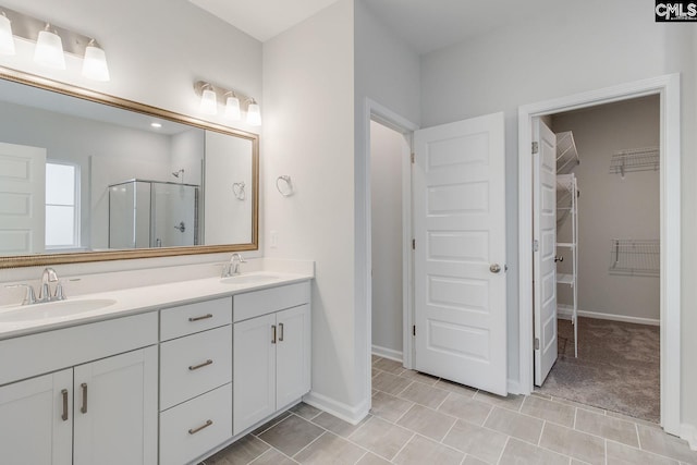 bathroom with vanity, a shower with shower door, and tile patterned flooring