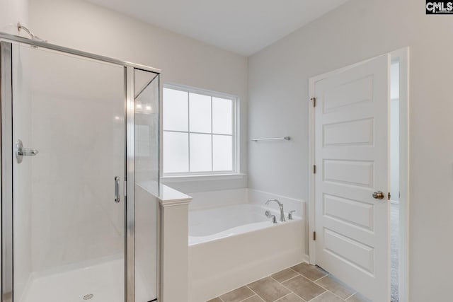 bathroom featuring tile patterned flooring and separate shower and tub