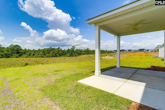 view of yard featuring a patio area and ceiling fan