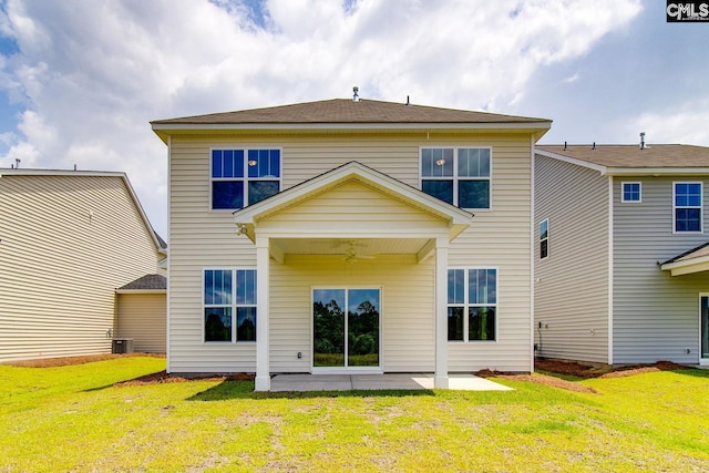 rear view of property featuring ceiling fan, central AC unit, a lawn, and a patio