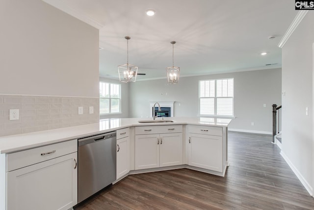 kitchen with crown molding, dishwasher, a peninsula, and a sink