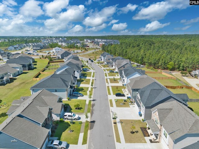 birds eye view of property with a residential view and a forest view