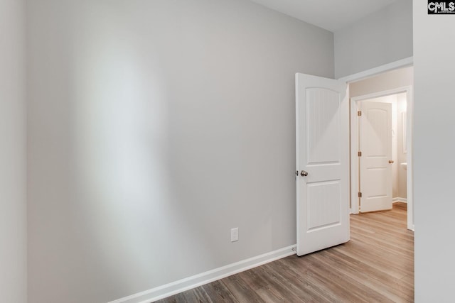 unfurnished room with wood finished floors and baseboards