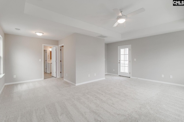 unfurnished room with light carpet, visible vents, and baseboards