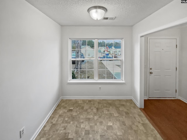 interior space featuring a textured ceiling