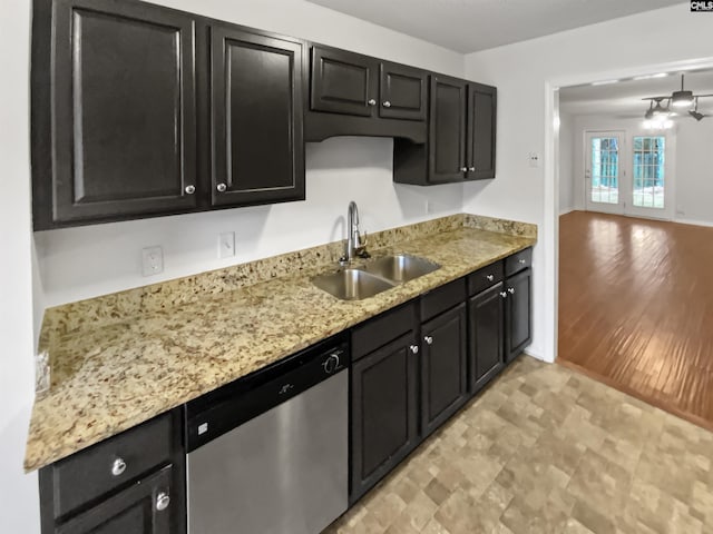 kitchen with dishwasher, sink, and light stone counters