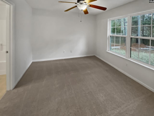 carpeted empty room featuring ceiling fan