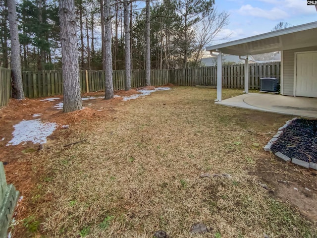 view of yard with central AC and a patio