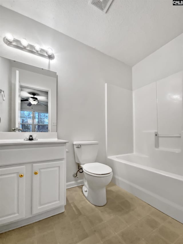 full bathroom with ceiling fan, vanity, a textured ceiling, bathtub / shower combination, and toilet