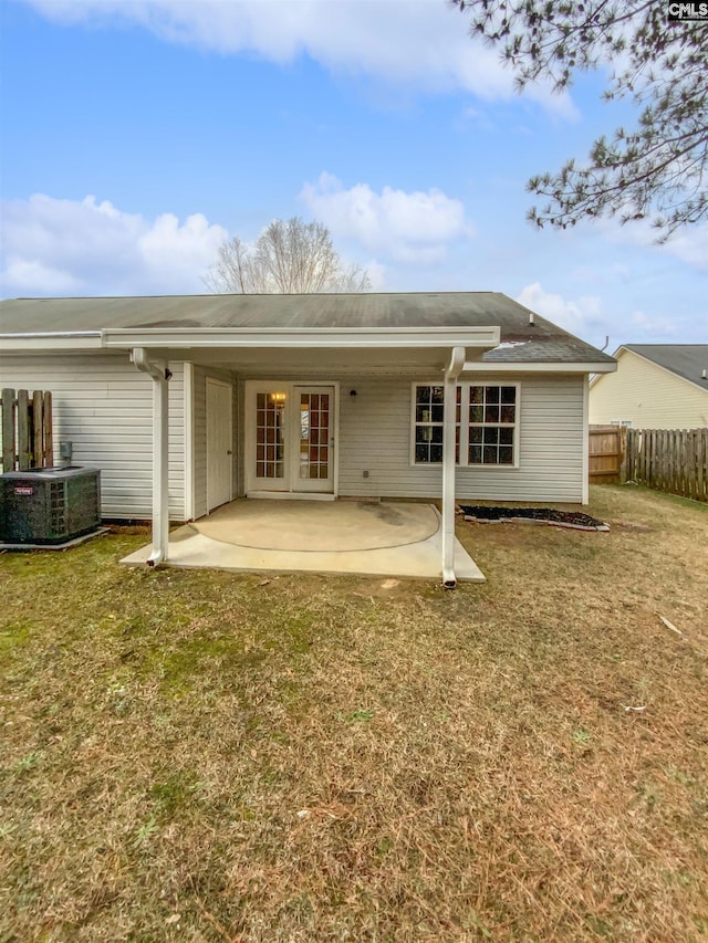 back of house featuring a yard, cooling unit, and a patio area