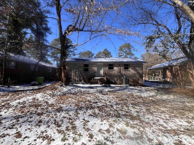 snow covered property featuring cooling unit