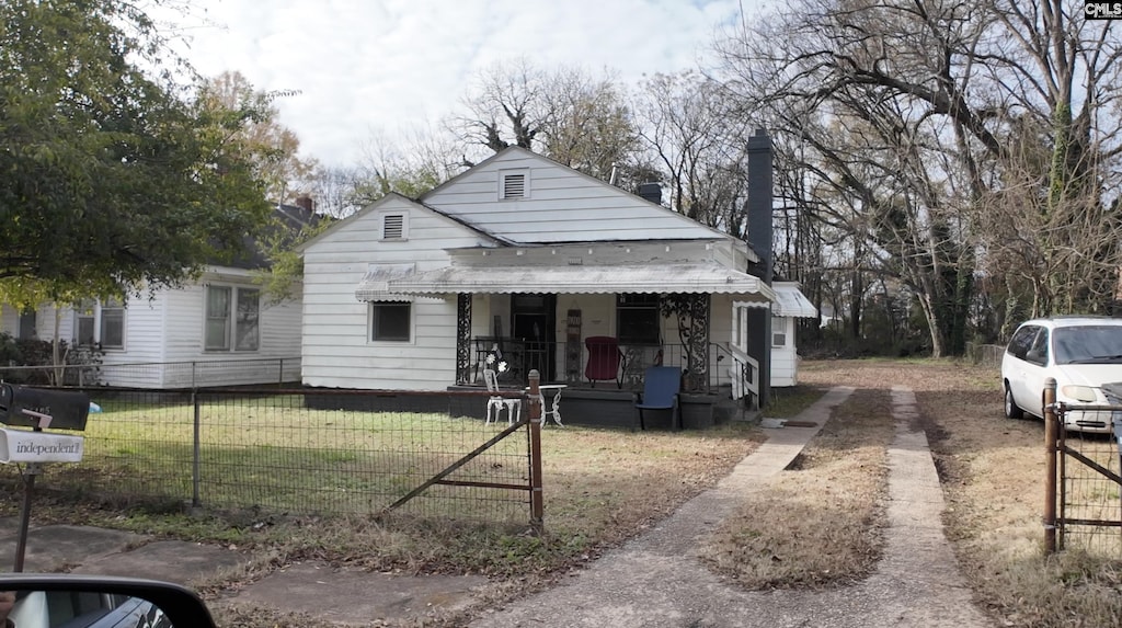 bungalow-style home with a porch and a front lawn