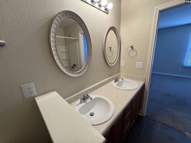 bathroom featuring tile patterned flooring and vanity