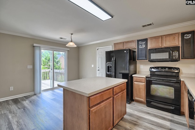 kitchen with crown molding, a kitchen island, pendant lighting, light hardwood / wood-style floors, and black appliances