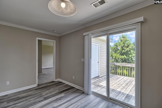 doorway to outside with ornamental molding and hardwood / wood-style floors