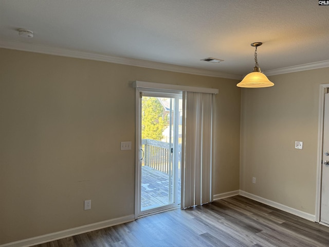 unfurnished room with crown molding and hardwood / wood-style flooring