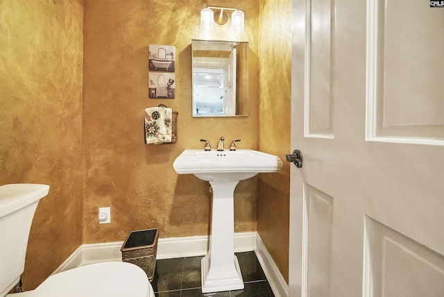 bathroom with tile patterned flooring, sink, and toilet