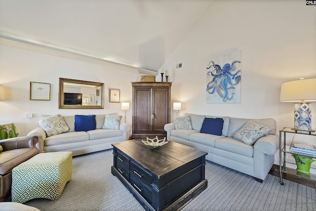 living room featuring carpet floors and vaulted ceiling