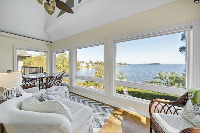 sunroom with a water view, a wealth of natural light, lofted ceiling, and ceiling fan