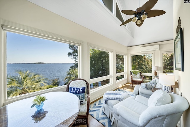 sunroom / solarium featuring a water view, ceiling fan, a wall mounted AC, and vaulted ceiling