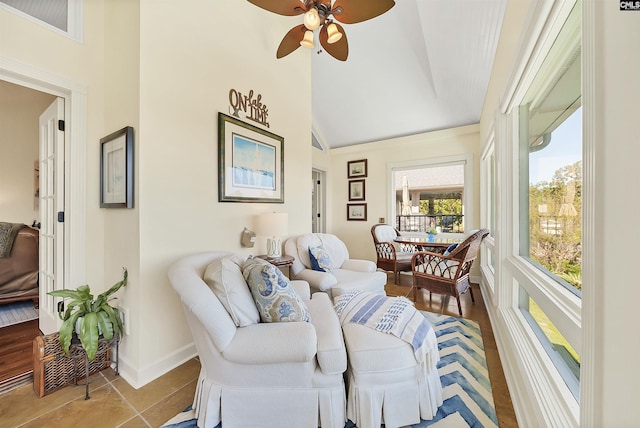 living room featuring light tile patterned flooring, lofted ceiling, and ceiling fan