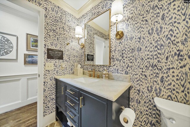 bathroom featuring vanity, crown molding, toilet, and hardwood / wood-style flooring