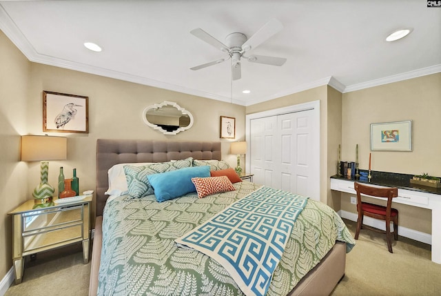 carpeted bedroom featuring ceiling fan, ornamental molding, built in desk, and a closet