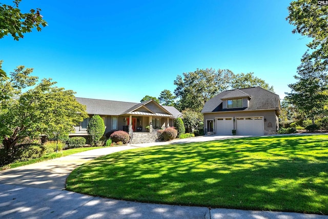 view of front of house with a garage, a front lawn, and covered porch