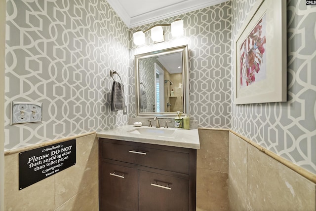 bathroom with ornamental molding and vanity