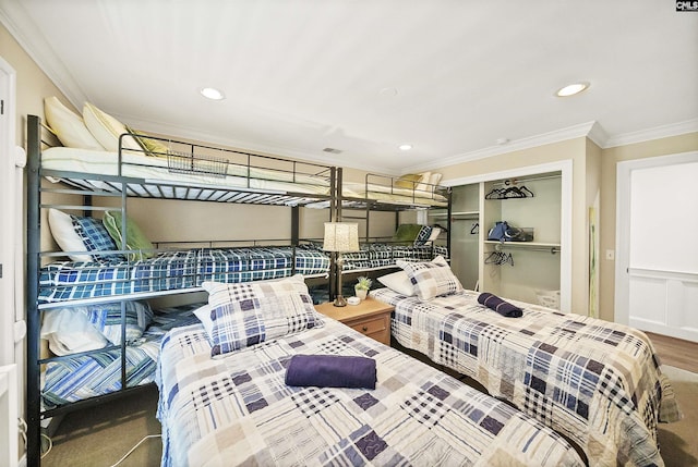 bedroom featuring ornamental molding, hardwood / wood-style floors, and a closet