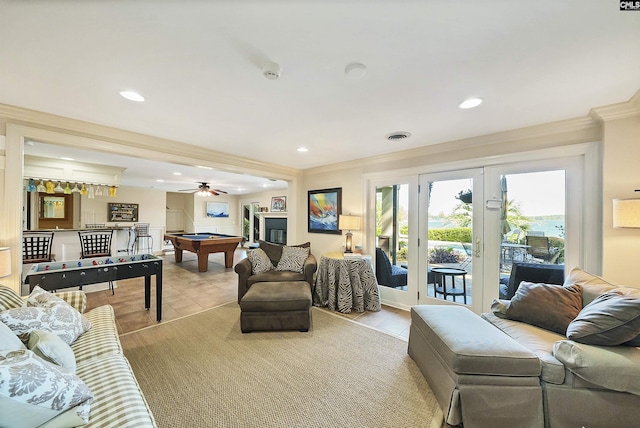 tiled living room featuring pool table, ornamental molding, and french doors