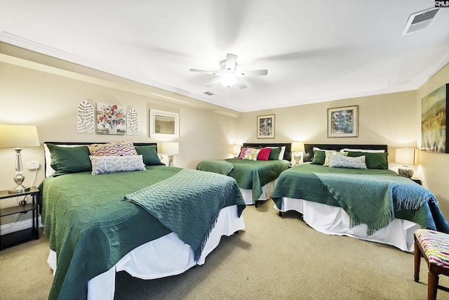 carpeted bedroom with crown molding and ceiling fan